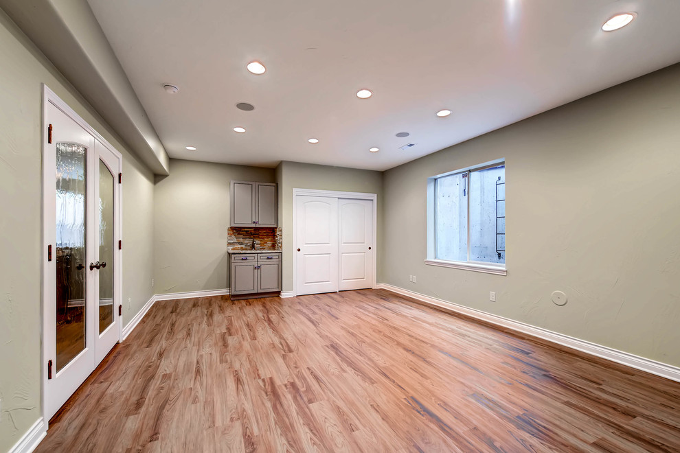 Mid-sized trendy walk-out ceramic tile and beige floor basement photo in Denver with beige walls and no fireplace