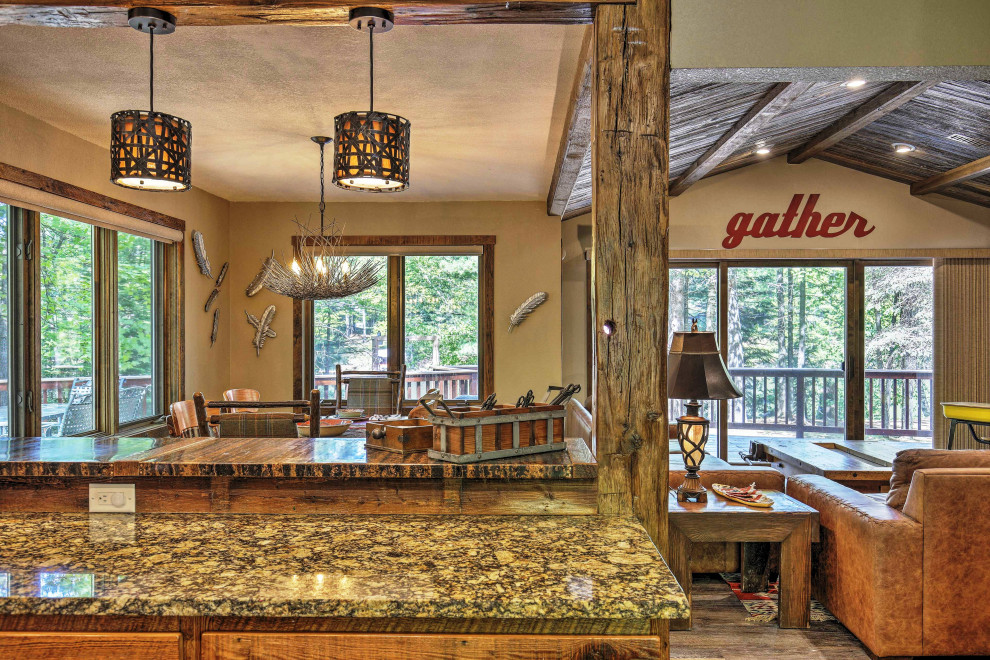 Eat-in kitchen - mid-sized rustic u-shaped vinyl floor and brown floor eat-in kitchen idea with a farmhouse sink, raised-panel cabinets, distressed cabinets, granite countertops, gray backsplash, stone tile backsplash, stainless steel appliances, an island and multicolored countertops