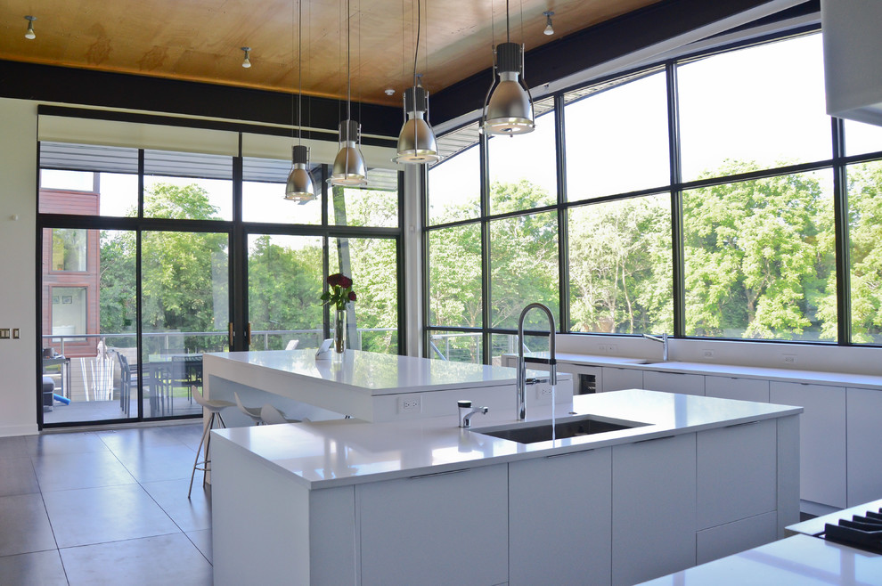 Inspiration for a large contemporary eat-in kitchen in Kansas City with an undermount sink, flat-panel cabinets, white cabinets, quartz benchtops, porcelain floors, multiple islands and grey floor.