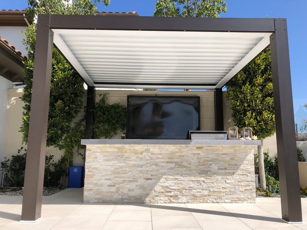 Photo of a mid-sized contemporary backyard patio in Orange County with an outdoor kitchen, tile and a gazebo/cabana.