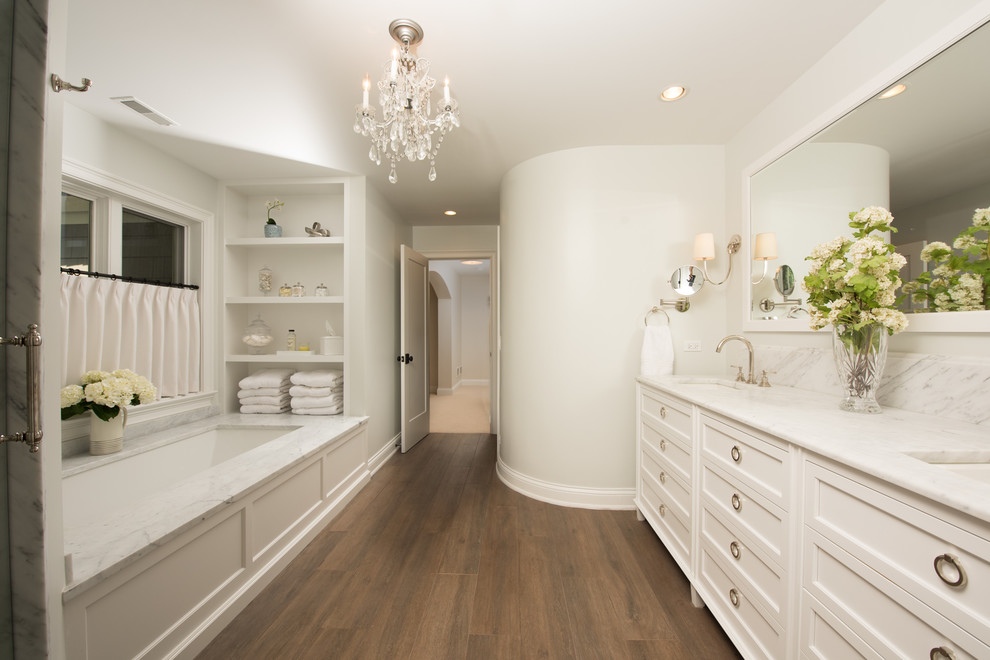Design ideas for a large traditional master bathroom in Chicago with white cabinets, engineered quartz benchtops, brown floor, shaker cabinets, a drop-in tub, grey walls, dark hardwood floors, a drop-in sink and grey benchtops.