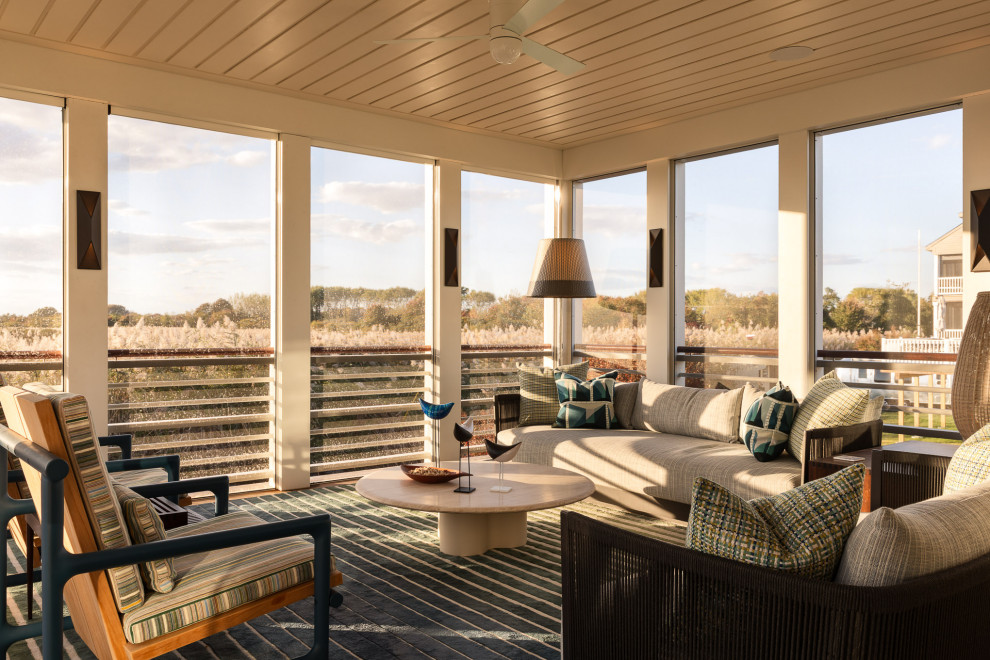 Inspiration for a coastal screened-in and wood railing porch remodel in Philadelphia with a roof extension