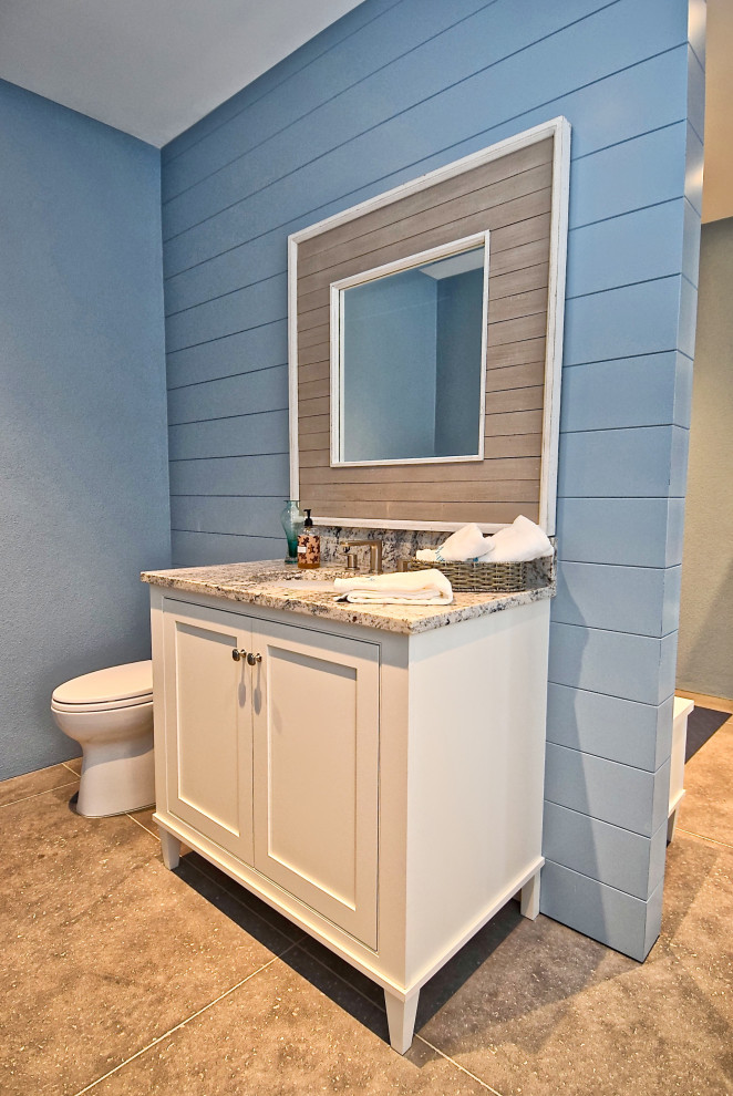 Inspiration for a large transitional bathroom in Tampa with beaded inset cabinets, white cabinets, a freestanding tub, blue tile, beige walls, marble floors, an undermount sink, quartzite benchtops, beige floor and brown benchtops.