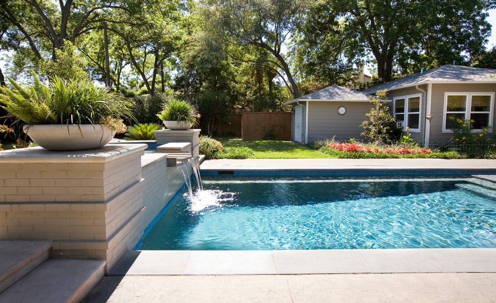 Design ideas for a mid-sized traditional backyard rectangular lap pool in Austin with a hot tub and natural stone pavers.