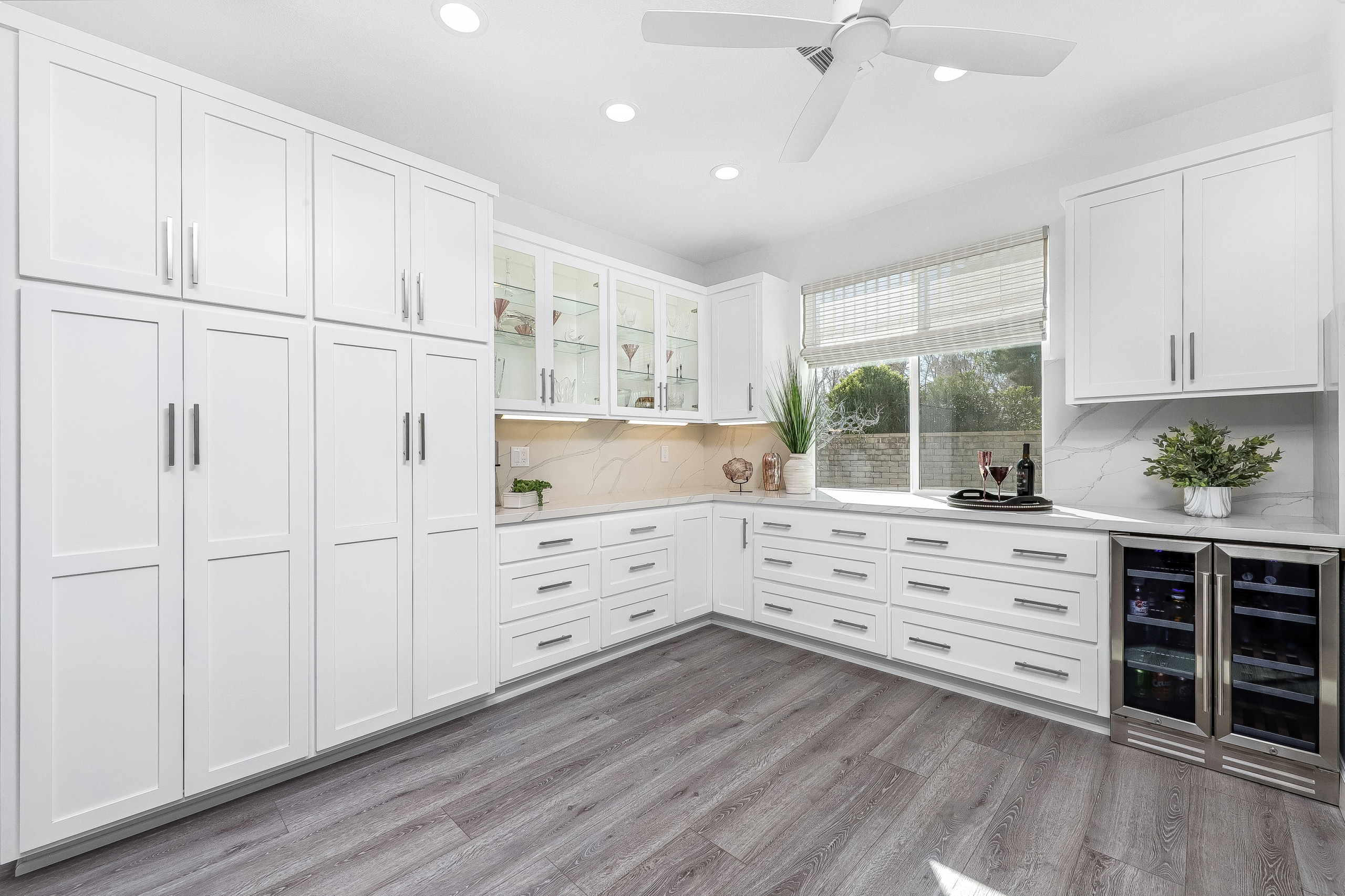 Custom Secondary Kitchen with Double Pantry in Shaker Style Cabinetry.