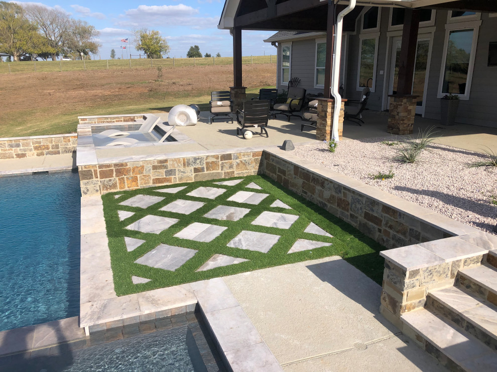 Photo of a small contemporary drought-tolerant and full sun backyard stone landscaping in Houston for summer.