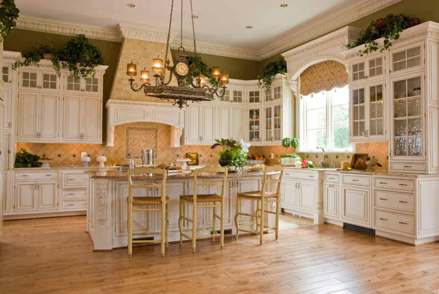 Mid-sized mountain style l-shaped light wood floor and beige floor kitchen pantry photo in DC Metro with raised-panel cabinets, beige backsplash, an island, a farmhouse sink, paneled appliances, white cabinets, granite countertops and ceramic backsplash