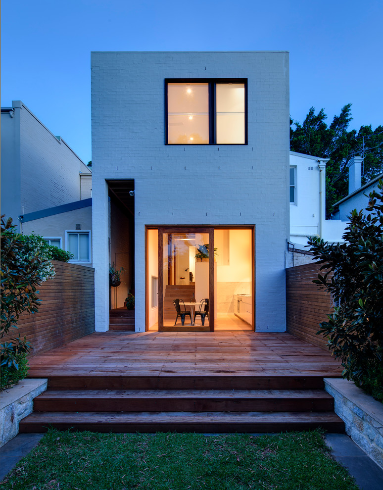 Photo of a mid-sized contemporary two-storey brick white exterior in Sydney with a flat roof.