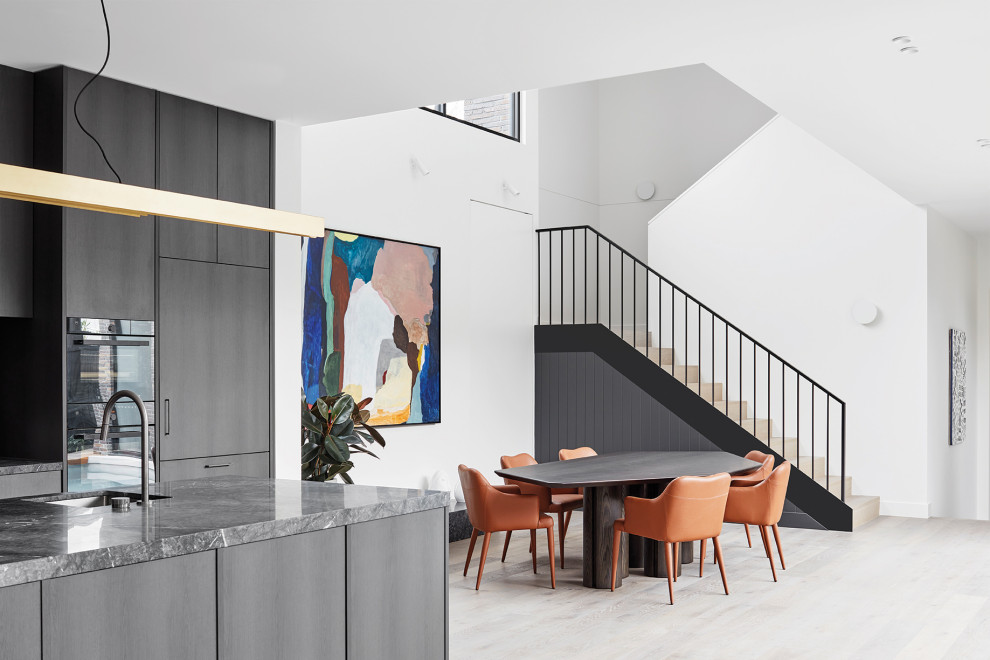 This is an example of a mid-sized contemporary open plan dining in Melbourne with decorative wall panelling, white walls, light hardwood floors and beige floor.