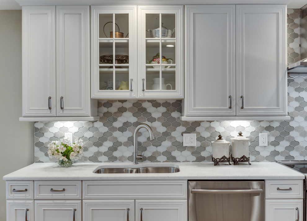 Inspiration for a large traditional galley kitchen in DC Metro with an undermount sink, recessed-panel cabinets, quartz benchtops, stainless steel appliances, medium hardwood floors and with island.