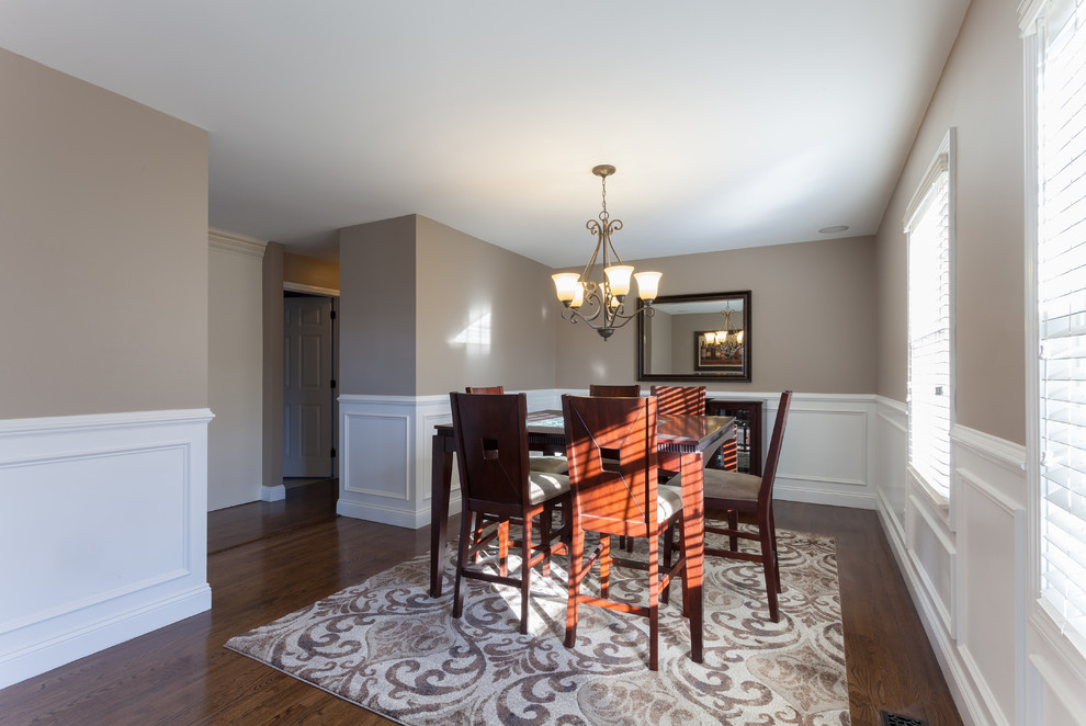 Mid-sized traditional separate dining room in Toronto with beige walls, dark hardwood floors, no fireplace and brown floor.