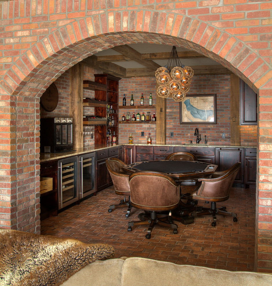 Inspiration for a country u-shaped home bar in Minneapolis with raised-panel cabinets, dark wood cabinets, granite benchtops, brown splashback, brick splashback, brick floors and brown floor.