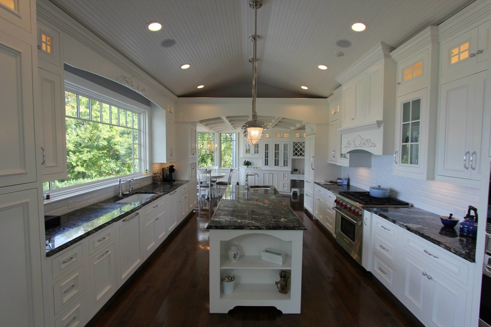 Traditional kitchen in New York with flat-panel cabinets, white cabinets, granite benchtops and white splashback.