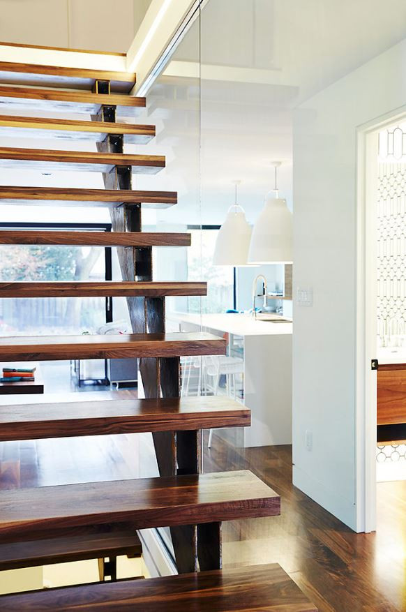 Design ideas for a mid-sized modern wood straight staircase in Toronto with open risers and wood railing.