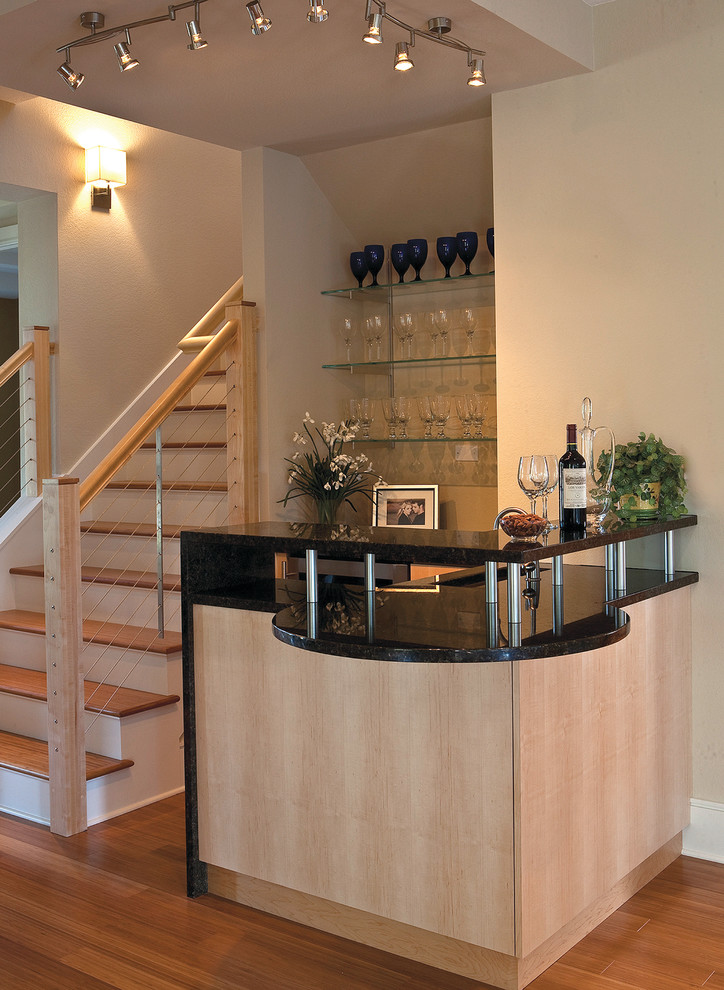 This is an example of a mid-sized arts and crafts l-shaped wet bar in Miami with an undermount sink, flat-panel cabinets, light wood cabinets, granite benchtops and medium hardwood floors.