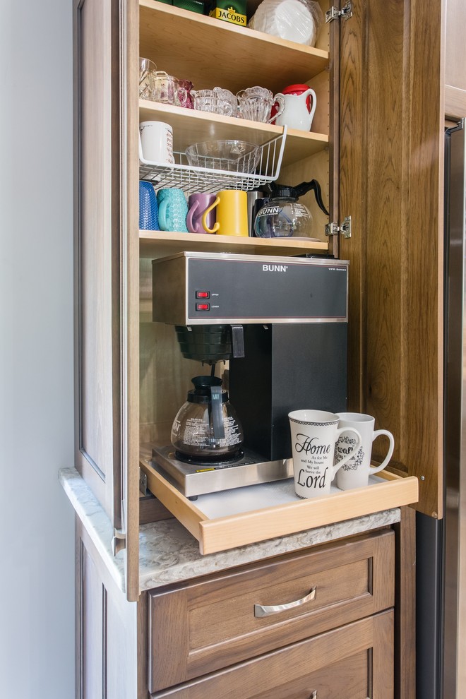 Example of a transitional l-shaped open concept kitchen design with shaker cabinets, stainless steel appliances and an island