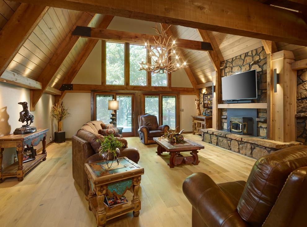 Country formal living room in Oklahoma City with beige walls, light hardwood floors, a standard fireplace and a wall-mounted tv.