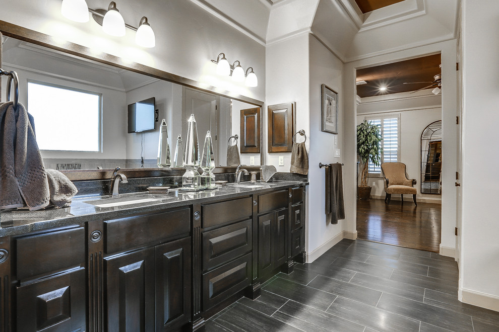 Design ideas for a mid-sized transitional master bathroom in Austin with raised-panel cabinets, dark wood cabinets, a drop-in tub, a corner shower, black tile, matchstick tile, white walls, porcelain floors, an undermount sink and granite benchtops.