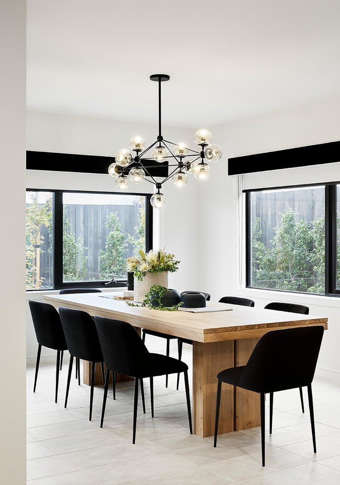 Contemporary separate dining room in Melbourne with white walls, no fireplace and beige floor.