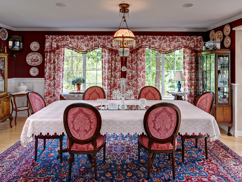 This is an example of a traditional dining room in Minneapolis with red walls.