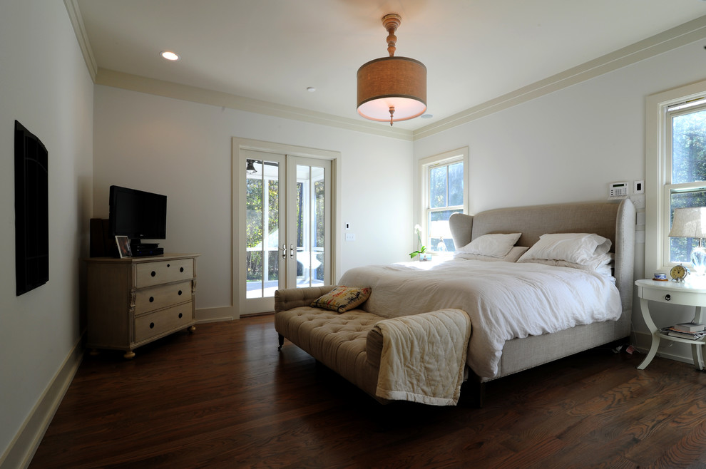 Photo of an arts and crafts master bedroom in San Francisco with grey walls, dark hardwood floors, a standard fireplace and a plaster fireplace surround.