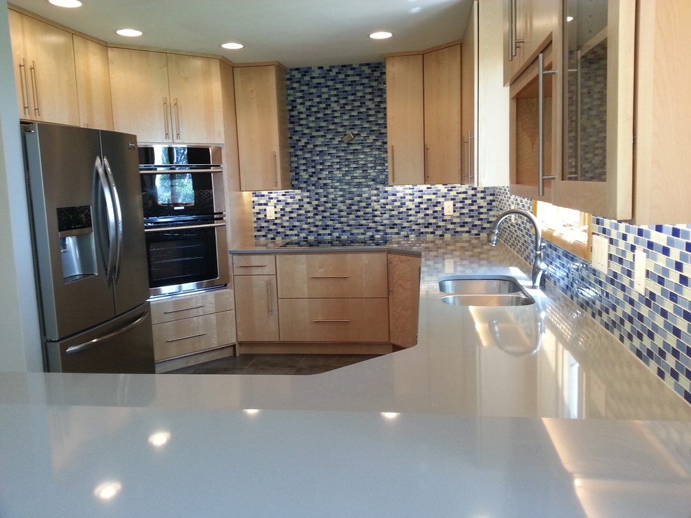 Inspiration for a mid-sized transitional u-shaped vinyl floor kitchen remodel in Cedar Rapids with an undermount sink, flat-panel cabinets, light wood cabinets, quartzite countertops, blue backsplash, mosaic tile backsplash, stainless steel appliances, gray walls and an island
