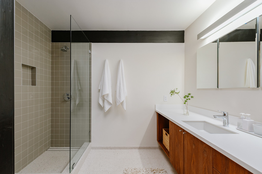 Inspiration for a large midcentury master bathroom in Los Angeles with flat-panel cabinets, medium wood cabinets, an undermount sink, solid surface benchtops, white floor, an open shower, white benchtops, a corner shower and white walls.