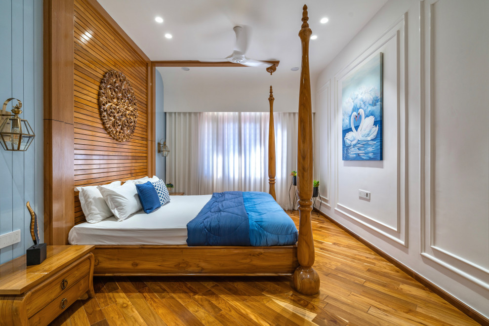 Design ideas for a contemporary bedroom in Ahmedabad With White Walls and Medium Hardwood Floors.