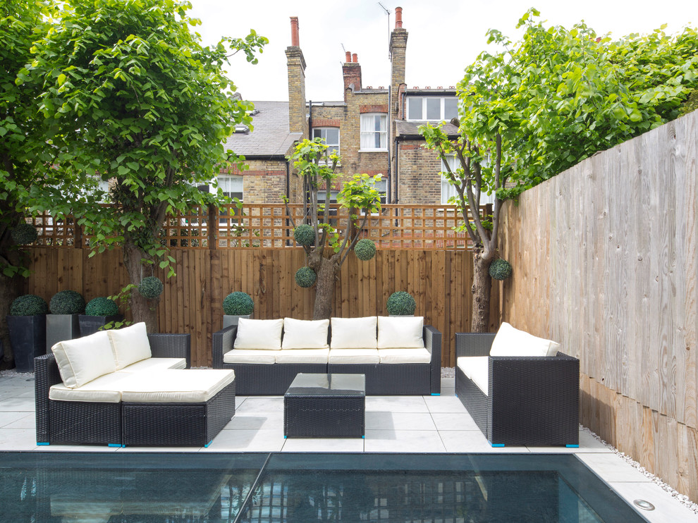 Design ideas for a mid-sized contemporary backyard patio in London with no cover.
