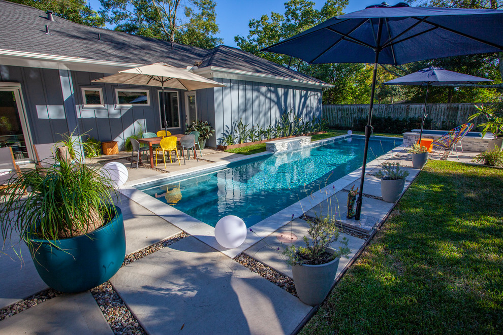 This is an example of a mid-sized modern backyard rectangular pool in Houston.