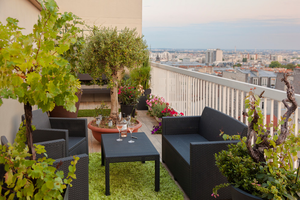 This is an example of a mid-sized contemporary balcony in Paris with a container garden and no cover.