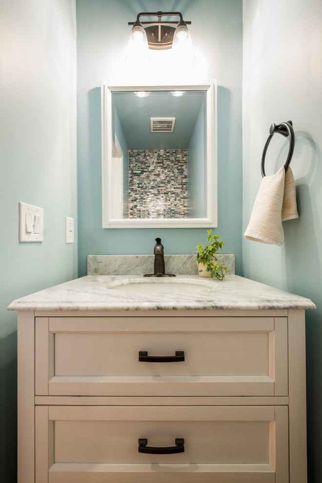 Small contemporary powder room with furniture-like cabinets, white cabinets, blue tile, glass sheet wall, engineered quartz benchtops and grey benchtops.