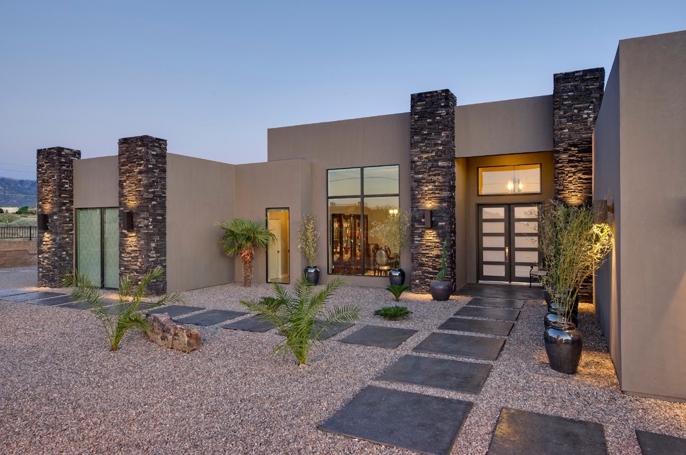 Photo of a large contemporary front door in Albuquerque with brown walls, a double front door, a glass front door and grey floor.