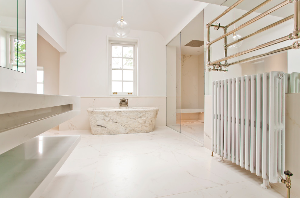 Photo of a large modern kids bathroom in Oxfordshire with a freestanding tub, an open shower, a wall-mount toilet, white tile, porcelain tile, white walls, porcelain floors, a wall-mount sink, quartzite benchtops, white floor, an open shower and white benchtops.