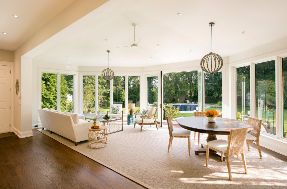 Design ideas for an expansive traditional sunroom in New York with medium hardwood floors, a standard ceiling and brown floor.