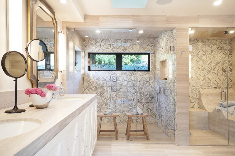 This is an example of a large master bathroom in Orange County with grey cabinets, a double shower, a two-piece toilet, gray tile, marble, white walls, limestone floors, an undermount sink, limestone benchtops, grey floor, a hinged shower door, grey benchtops and recessed-panel cabinets.