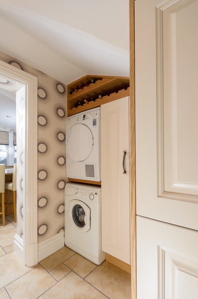 Traditional laundry room in Manchester with a stacked washer and dryer.