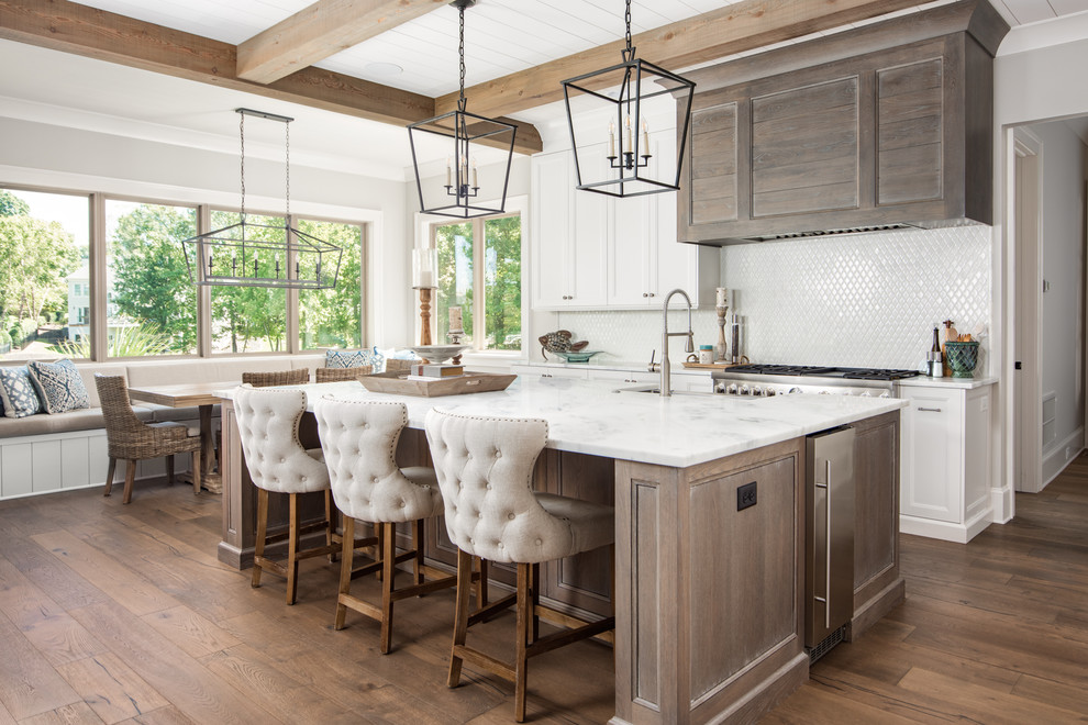 Design ideas for a beach style galley eat-in kitchen in Charlotte with an undermount sink, recessed-panel cabinets, dark wood cabinets, white splashback, mosaic tile splashback, stainless steel appliances, dark hardwood floors, with island and brown floor.
