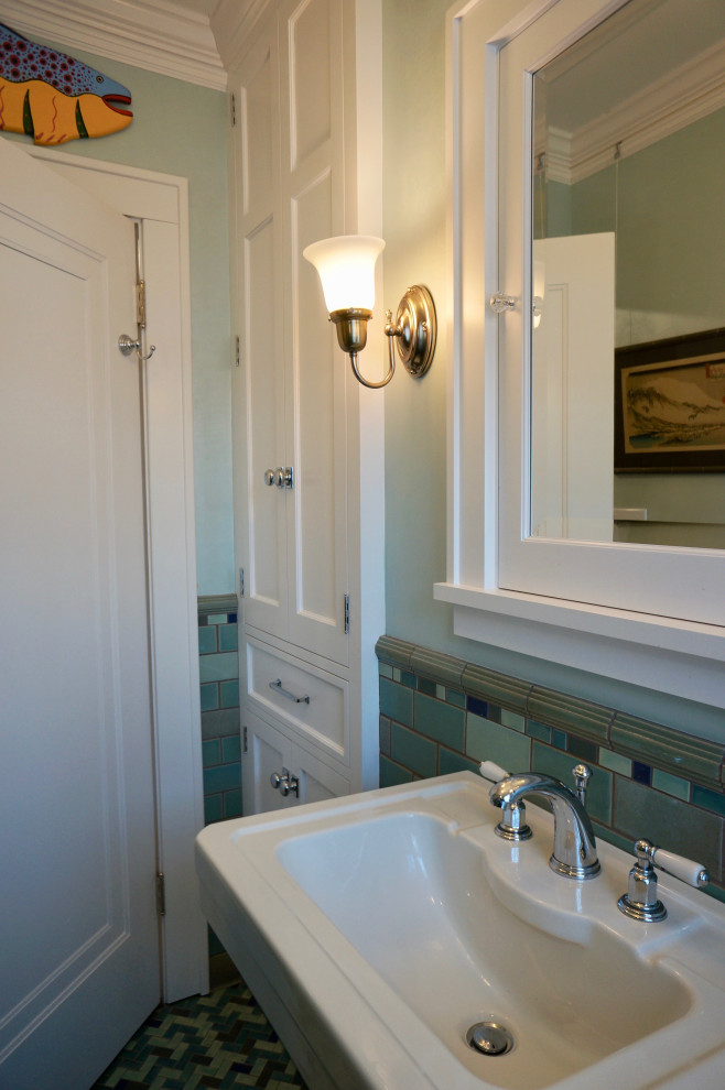 Small traditional 3/4 bathroom in Minneapolis with an alcove shower, blue tile, ceramic tile, blue walls, a pedestal sink, a hinged shower door, a one-piece toilet, ceramic floors, green floor, a shower seat and a single vanity.