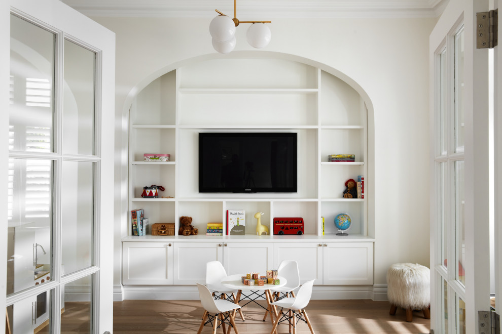 This is an example of a transitional gender-neutral kids' playroom in Sydney with white walls, medium hardwood floors and brown floor.