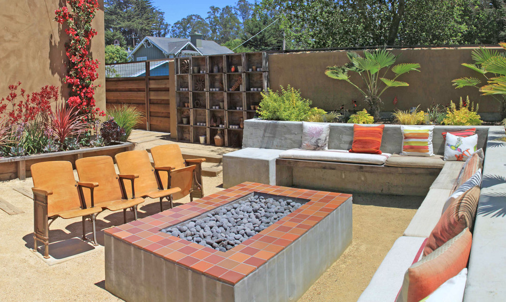 Inspiration for a large mediterranean backyard patio in San Francisco with decomposed granite, no cover and a fire feature.