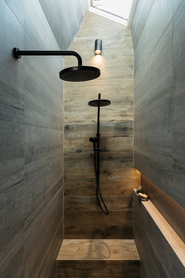 This is an example of a large contemporary 3/4 bathroom in Adelaide with furniture-like cabinets, light wood cabinets, a corner shower, gray tile, grey walls, porcelain floors, porcelain tile, tile benchtops, brown floor, an open shower and brown benchtops.