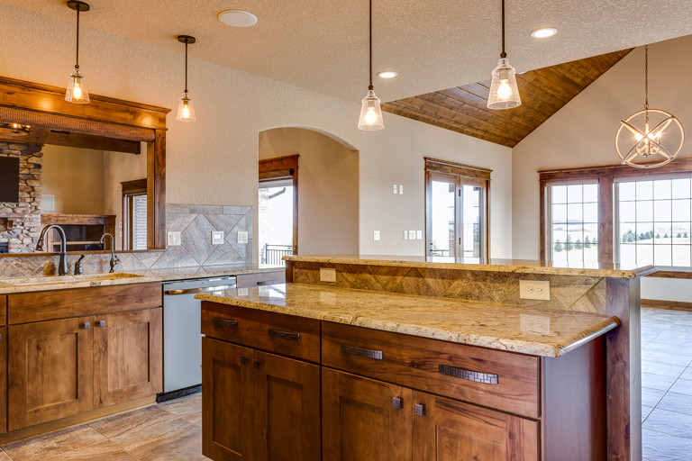 Mountain style u-shaped eat-in kitchen photo with shaker cabinets and an island