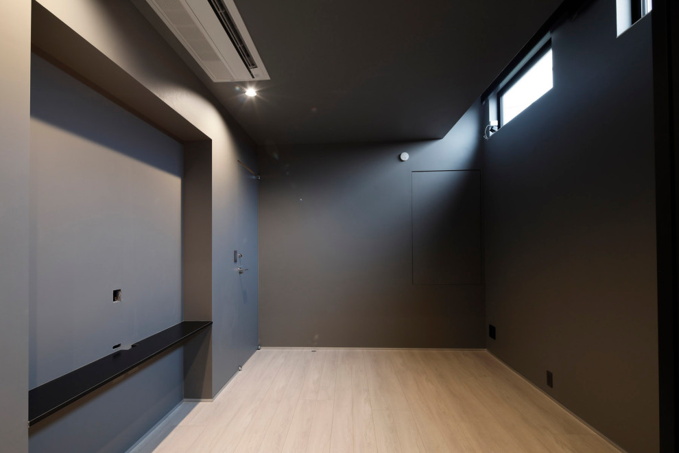 Photo of an industrial master bedroom in Tokyo with black walls, light hardwood floors, white floor, recessed and wallpaper.