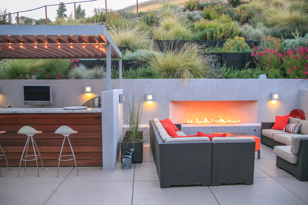 Photo of a mid-sized contemporary backyard patio in San Francisco with a fire feature and concrete pavers.