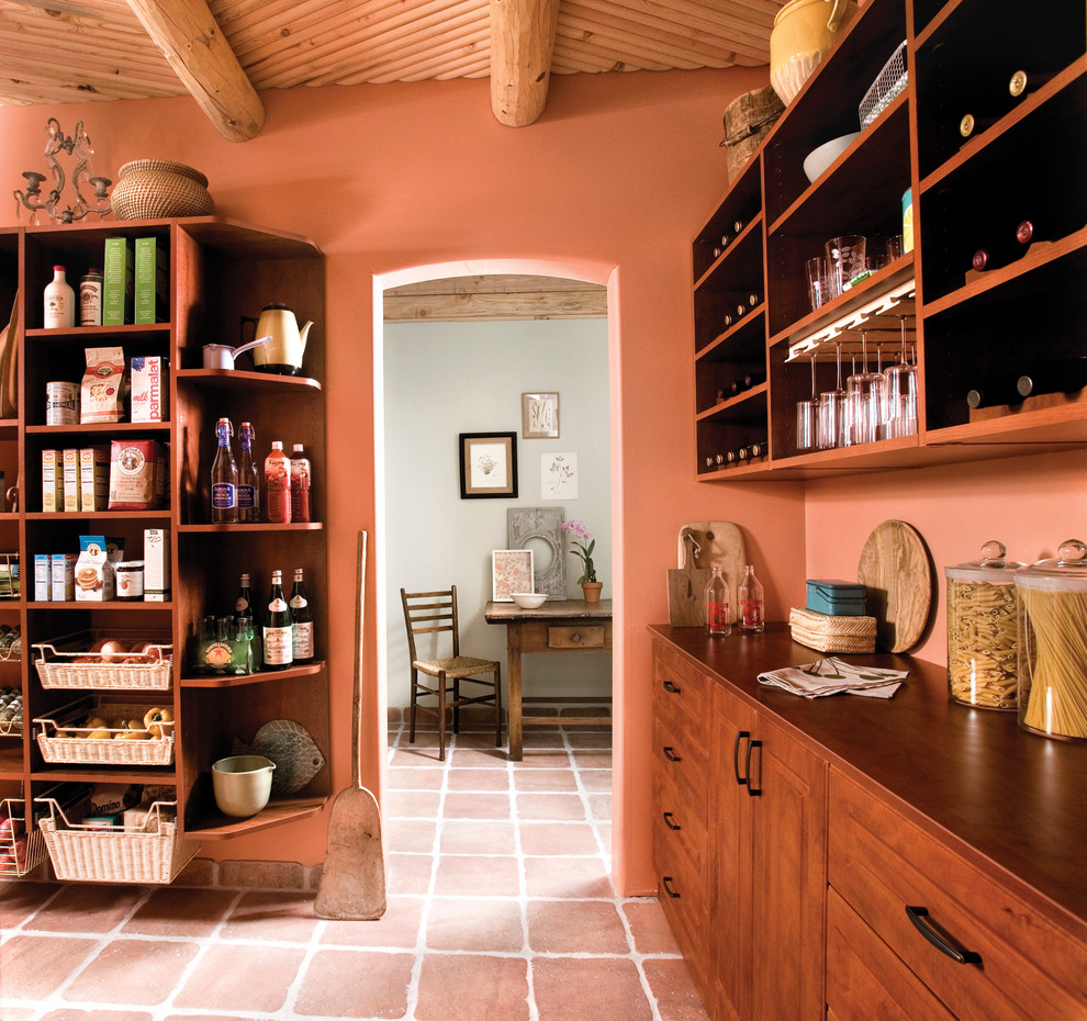 Inspiration for an expansive country kitchen pantry in Boston with raised-panel cabinets, medium wood cabinets, wood benchtops, orange splashback and terra-cotta floors.