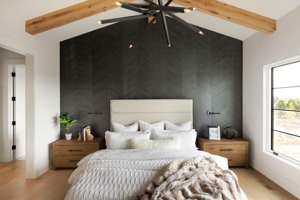 Inspiration for a transitional master bedroom in Minneapolis with light hardwood floors, vaulted and wallpaper.