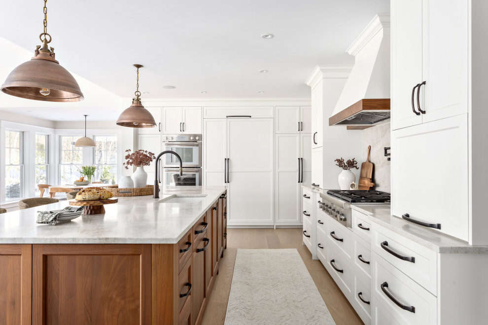 Large transitional l-shaped medium tone wood floor and brown floor open concept kitchen photo in Other with an undermount sink, shaker cabinets, quartz countertops, multicolored backsplash, quartz backsplash, stainless steel appliances, an island, beige countertops and white cabinets