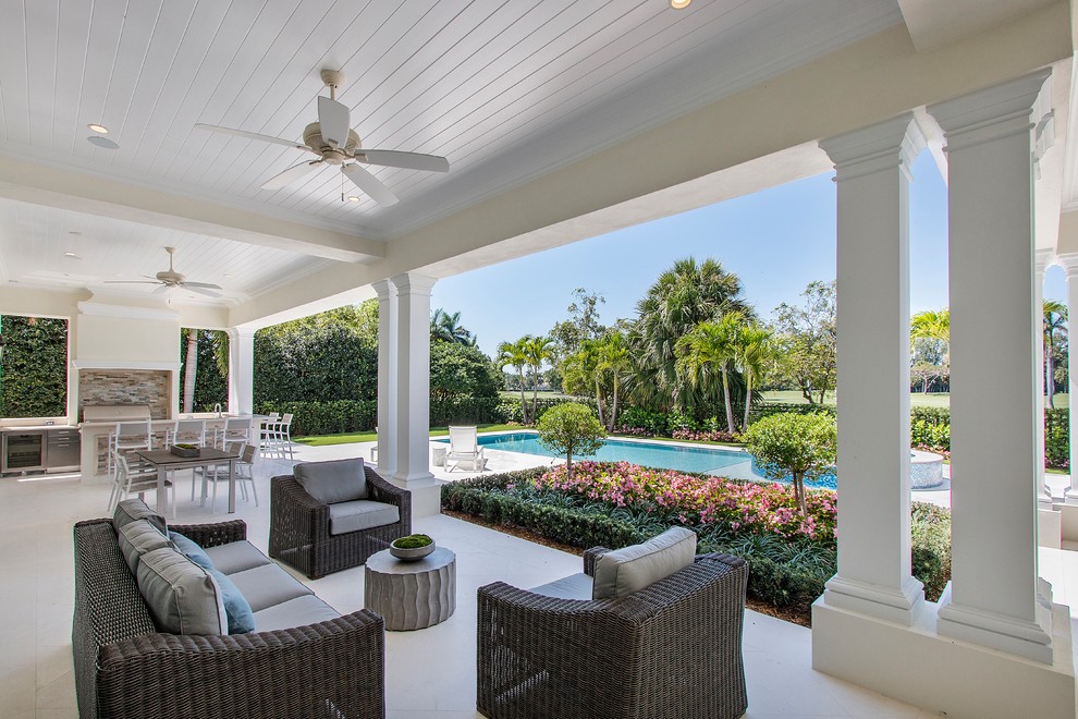 Mediterranean backyard verandah in Miami with a roof extension.