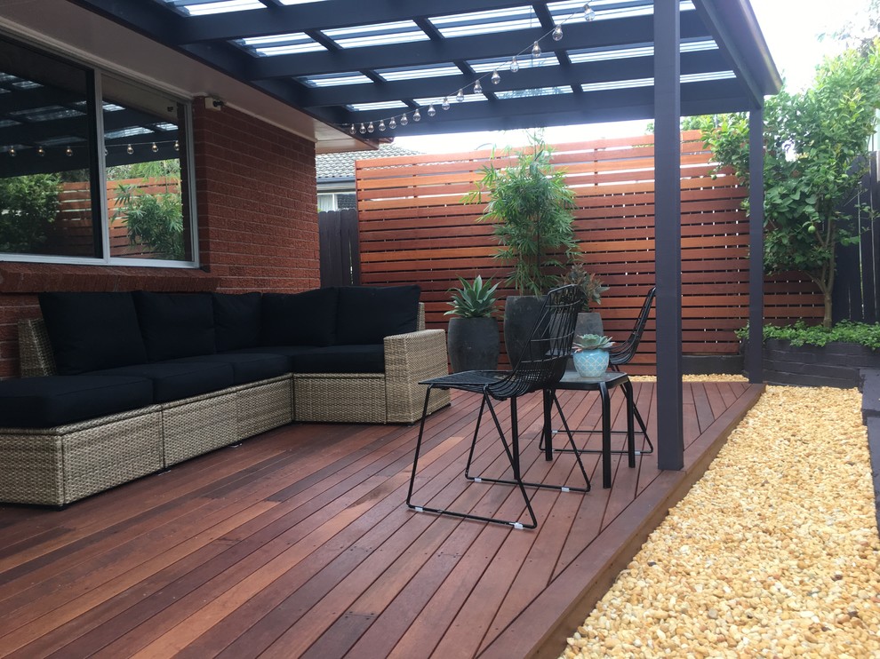 Inspiration for a mid-sized modern backyard deck in Sydney with a pergola.